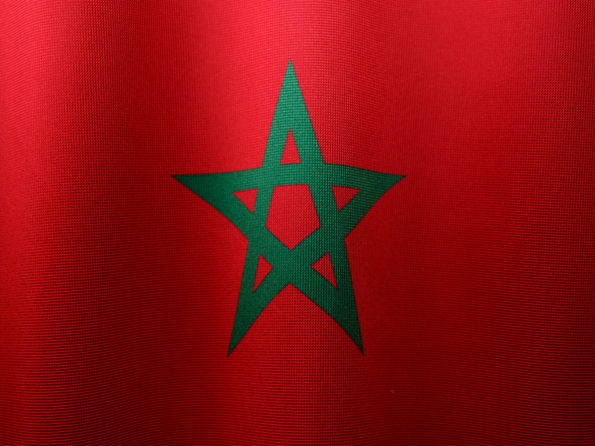 Detailed close-up of the Moroccan flag, highlighting its vibrant colors and iconic green star.